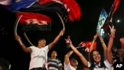 Supporters of Nicaragua's President Daniel Ortega and vice presidential candidate, his wife, Rosario Murillo wave flags of the Sandinista National Liberation Front, or FSLN, as Ortega won re-election, while celebrating in Managua, Nicaragua, Nov. 6, 2016.