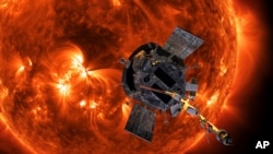FILE - This image made available by NASA shows an artist's rendering of the Parker Solar Probe approaching the sun. NASA said on Friday that the probe was operating normally after completing the closest-ever approach to the sun by any human-made object. 