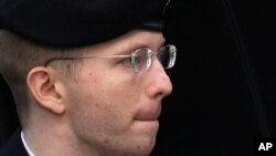FILE - Army Pfc. Chelsea Manning, then-Army Pfc. Bradley Manning, is escorted into a courthouse in Fort Meade, Maryland, Aug. 21, 2013, before a sentencing hearing in his court martial. 