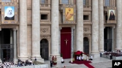 The tapestries, from left, of Laura di Santa Caterina da Siena Montoya of Colombia, Antonio Primaldo and his companions, also known as the Martyrs of Otranto, and Maria Guadalupe Garcia Zavala of Mexico hang from balconies in St. Peter's Square at the Vatican, May 12, 2013, as Pope Francis celebrate the canonization ceremony for the three new saints. 