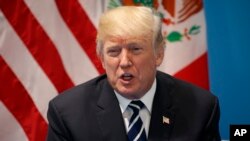 FILE - President Donald Trump speaks during a meeting with Mexican President Enrique Pena Nieto at the G20 Summit in Hamburg, July 7, 2017.