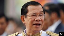 FILE - Cambodia's Prime Minister Hun Sen waits to attend Independence Day celebrations in Phnom Penh, Cambodia, Nov. 9, 2017.