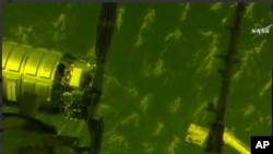 In this image made from video provided by NASA, the S.S. John Glenn cargo ship prepares to dock with the International Space Station, April 22, 2017.