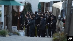 Police arrive at the gate of the presidential residence as supporters of impeached South Korean President Yoon Suk Yeol rally against a court's issuance of a warrant to detain Yoon, in Seoul, South Korea, Jan. 3, 2025. 