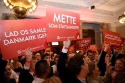 FILE - Supporters of Danish Social Democrats celebrate in the parliament in Copenhagen, Denmark, June 5, 2019.