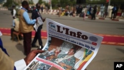 A journalist reads a local newspaper bearing the late Chadian president Idriss Deby on the front page, during the state funeral for Deby in N'Djamena, Chad, April 23, 2021. 