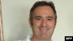 U.S. President Barack Obama reacts as he reads a card during a game with children in a per-kindergarten classroom at College Heights Early Childhood Learning Center in Decatur, Georgia. 