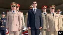 Syrian President Bashar Assad, center, General Hassan Turkmani, right, and General Ali Habib, chief of staff, left, tomb of the unknown martyr, near Damascus, Oct. 6, 2007.