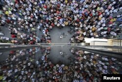 People are reflected on a building as they take part in a pro-EU demonstration in Iraklio on the island of Crete, Greece, July 2, 2015.