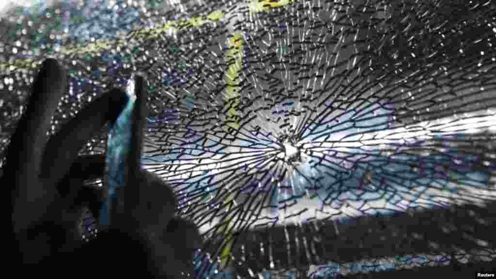 A bus carrying journalists at the Rio Games was struck by projectiles, slightly injuring two people and prompting a police investigation, Aug. 9, 2016.