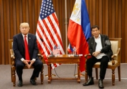 FILE - U.S. President Donald Trump, left, and Philippine President Rodrigo Duterte hold a bilateral meeting on the sidelines of an ASEAN Summit in Manila, Philippines, Nov. 13, 2017.