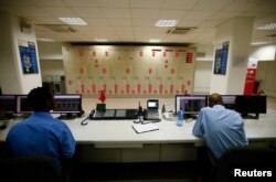 Engineers work in the control room of Gibe III hydroelectric dam in in Ethiopia, Dec. 16, 2016.
