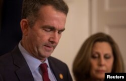 Virginia Governor Ralph Northam, accompanied by his wife Pamela Northam, announces he will not resign, during a news conference in Richmond, Virginia, Feb. 2, 2019.