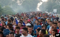 Central American migrants walking to the U.S. start their day departing Ciudad Hidalgo, Mexico, Oct. 21, 2018.