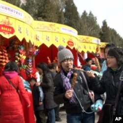 Chinese visitors enjoy snacks at this year's Spring Festival fair at the Yuanming Yuan park