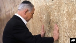 Israeli Prime Minister Benjamin Netanyahu prays at the Western Wall in Jerusalem's Old City, Feb. 28, 2015.