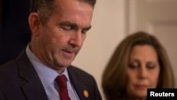 Virginia Governor Ralph Northam, accompanied by his wife Pamela Northam, announces he will not resign, during a news conference in Richmond, Virginia, Feb. 2, 2019.