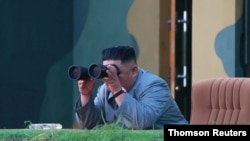 North Korean leader Kim Jong Un watches the test-fire of two short-range ballistic missiles Thursday, in this undated picture released by North Korea's Central News Agency, July 26, 2019. 