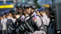 Indonesian police officers deploy with their riot gear in Jakarta, Indonesia, Dec. 23, 2015.