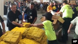 Warren Heslip, 47, of Southland, New Zealand, receives a yellow firefighting shirt, Aug. 24, 2015 at the National Interagency Fire Center in Boise, Idaho.