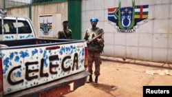 A fighter from the Seleka rebel coalition stands guard in front of the abandoned South African military camp in Bangu on March 26, 2013.