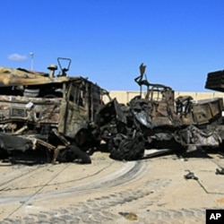 Destroyed military vehicles are seen at a naval military facility after last night's coalition air strikes in People's Port in eastern Tripoli, March 22, 2011
