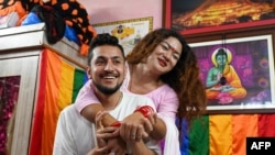 FILE - In this picture taken on Aug. 30, 2023, Surendra Pandey, left, and Maya Gurung, a transgender woman, are shown in Kathmandu.