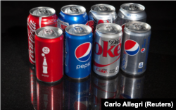 FILE - Soda, pop, or Coke? Regular and mini cans of Coke and Pepsi are pictured in this photo illustration in New York, August 5, 2014. (REUTERS/Carlo Allegro/File Photo)