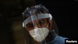 A man wearing a protective mask and visor is seen in London, as the spread of the coronavirus disease (COVID-19) continues, April 13, 2020. 