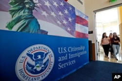 FILE - People arrive before the start of a naturalization ceremony at the U.S. Citizenship and Immigration Services Miami Field Office in Miami, Florida, Aug. 17, 2018.