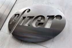 FILE - The Pfizer company logo is seen at the company's headquarters in New York, Dec. 4, 2017.