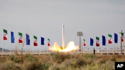 FILE - In this photo released April 22, 2020, by Sepahnews, an Iranian rocket carrying a satellite is launched from an undisclosed site believed to be in Iran's Semnan province.