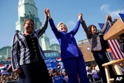 Democratic presidential candidate Hillary Clinton, center, celebrates at a rally with Rep. Karen Bass, D-Calif., left, and Rep. Maxine Waters, D-Calif., Monday, June 6, 2016.