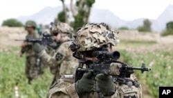 A US soldier from 3rd platoon Bronco troop 5-20 infantry Regiment attached to 82nd Airborne looks through his sights while on patrol with Afghan National Army soldiers in Zharay district in Kandahar province, southern Afghanistan, April 21, 2012. 