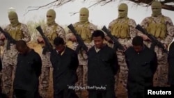 Militants from the so-called Islamic State stand behind what are said to be Ethiopian Christians in Libya, in this still image from an undated video posted to a social media website on April 19, 2015.