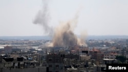 Smoke rises following what witnesses said was an Israeli air strike in Rafah in the southern Gaza Strip, Aug. 8, 2014.