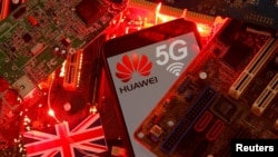 FILE - The British flag and a smartphone with a Huawei and 5G network logo are seen on a PC motherboard in this illustration picture taken Jan. 29, 2020.