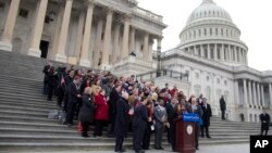 Actress America Ferrera, surrounded by House Democrats and immigration leaders, speaks during a new conference to announce a DemandAVote discharge petition, on the steps of the Capitol in Washington, March 26, 2014.