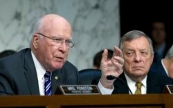 FILE - Sen. Patrick Leahy, D-Vt., left, accompanied by Sen. Dick Durbin, D-Ill., attend a Senate Judiciary Committee hearing on Capitol Hill, Jan. 16, 2018.