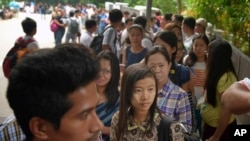 FILE - Myanmar citizens wait for their turn outside the Myanmar Embassy in Singapore to cast advance ballots in the country's Nov. 8 general election, Oct. 18, 2015. 