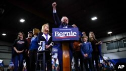 Democratic presidential candidate Sen. Bernie Sanders, accompanied by his wife Jane O'Meara Sanders and other family members speaks during a primary night election rally in Essex Junction, Vt., March 3, 2020.