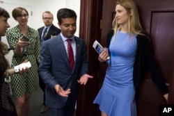 Florida Republican Rep. Carlos Curbelo is followed by reporters as he arrives for the Republican Caucus meeting on Capitol Hill in Washington, May 2, 2017.