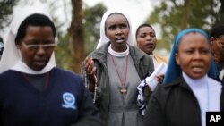Catholic nuns pray near the Westgate Mall in Nairobi, Kenya, Sept. 25 2013. 
