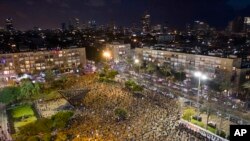 People maintain social distancing amid concerns over the country's coronavirus outbreak, during a "Black Flag" protest against Prime Minister Benjamin Netanyahu and government corruption, at Rabin Square in Tel Aviv, Israel, April 25, 2020.