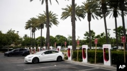 FILE - Tesla electric vehicles are charged at a charging station in Anaheim, Calif., June 9, 2023. EV sales are expected to hit a record 9% of all passenger vehicles in the U.S. this year, according to Atlas Public Policy. 