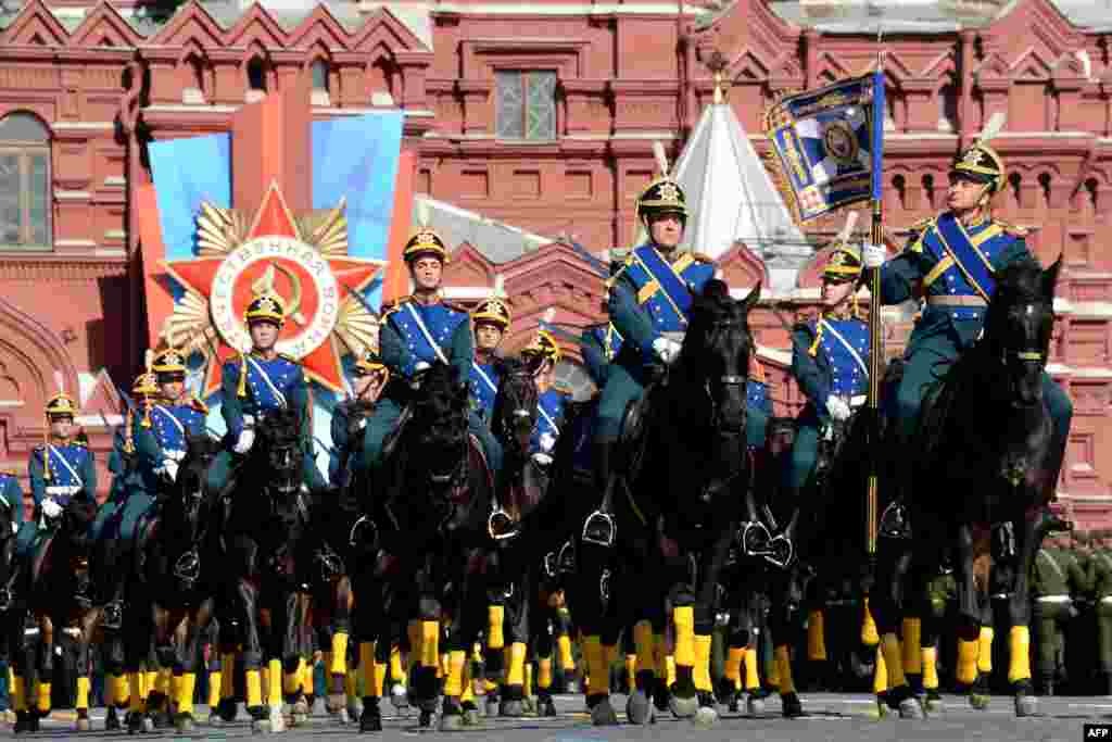 Russian honor guard troopers ride during a Victory Day parade at the Red Square in Moscow.