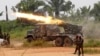 FILE - Democratic Republic of Congo soldiers launch missiles during a military operation against ADF rebels outside the town of Beni, in North Kivu province, Jan. 18, 2014.