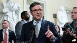 Speaker of the House Mike Johnson talks to reporters after passing the funding bill to avert the government shutdown at the Capitol in Washington, Dec. 20, 2024.