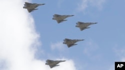 FILE - Taiwan's Mirage 2000 fighter jets fly in close formation over President Office during National Day celebrations in front of the Presidential Building in Taipei, Oct. 10, 2021.