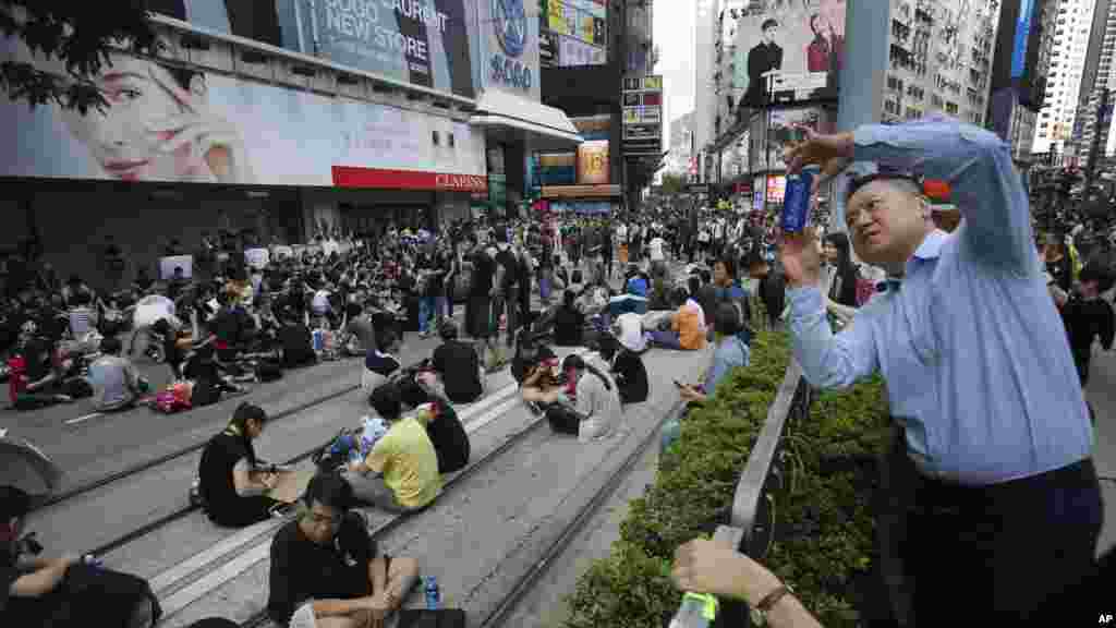 A visitor takes a photo of a sit-in protest in Hong Kong, Sept. 29, 2014. 